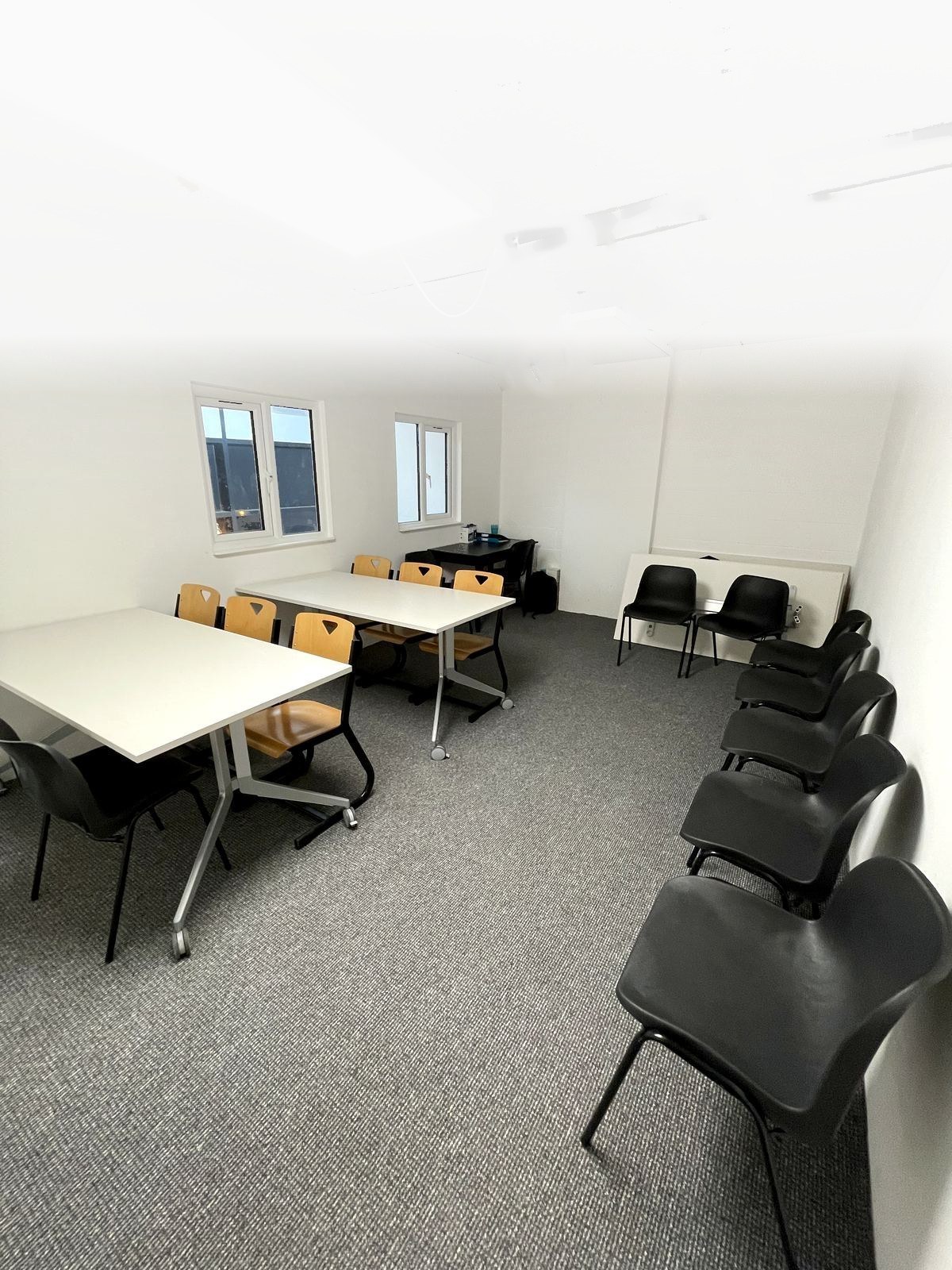 Upstairs teaching room with tables and whiteboard